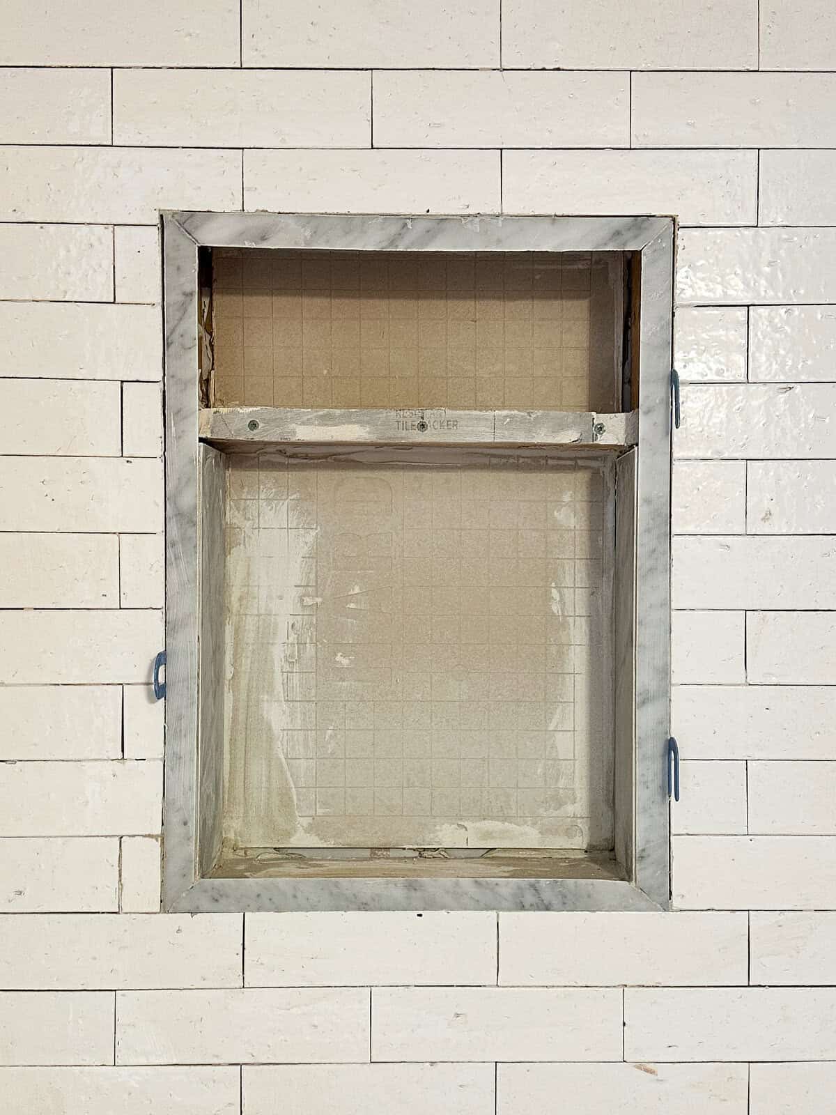 the shower wall niche with marble border