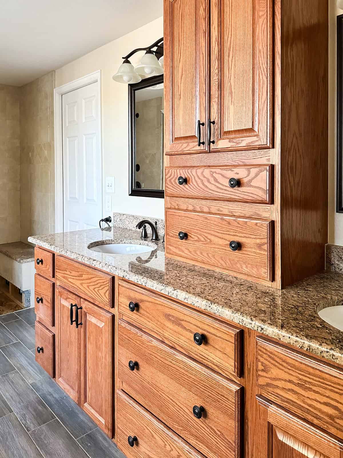 The existing vanity with granite countertop in the primary bathroom