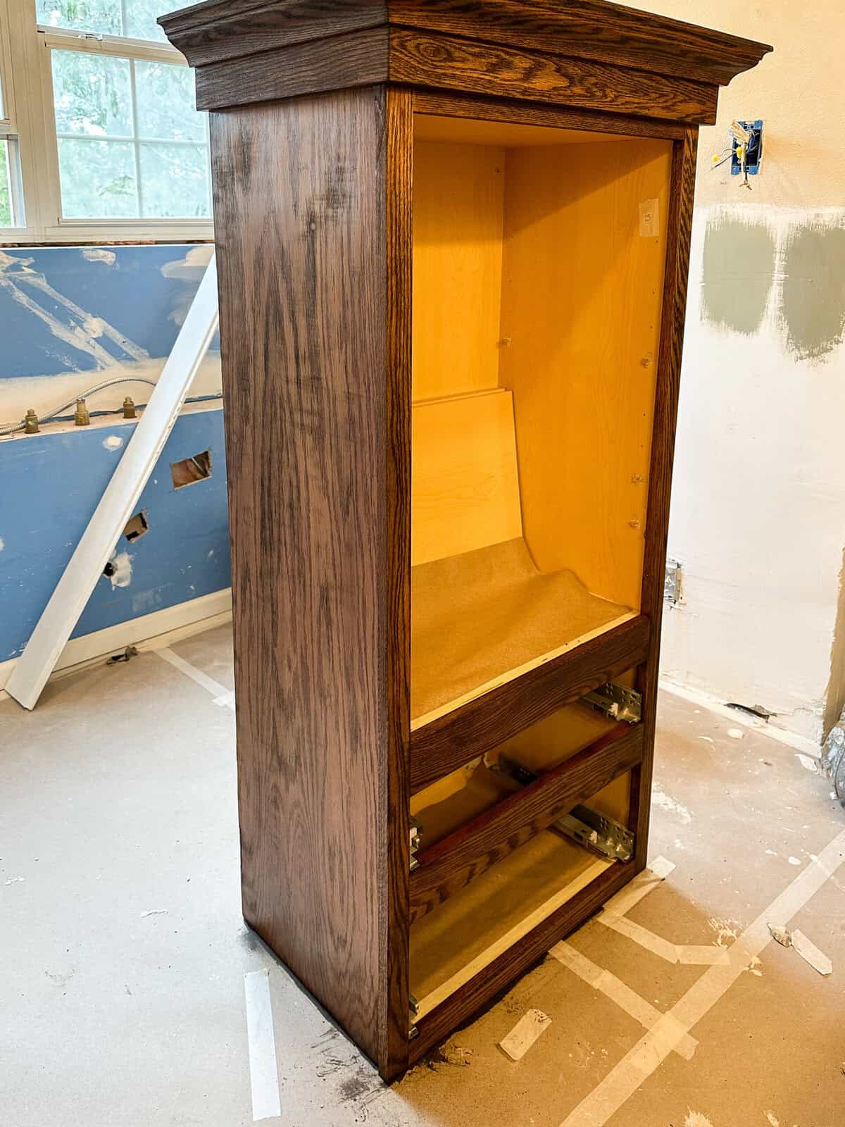 bathroom vanity makeover - the top cabinet after one layer of stain